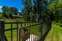Inviting fenced dog park with lush green grass, surrounded by trees, perfect for large dogs to enjoy.