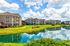 Charming apartment community with serene lakeside views and lush green landscaping, offering a peaceful and picturesque living environment.