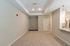 Inviting apartment interior showcasing an open living space with modern neutral decor and plush carpeting.