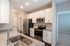Modern kitchen with sleek stainless steel appliances, elegant granite countertops, and ample cabinetry for stylish and functional living.