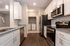 Modern kitchen with sleek granite countertops, stainless steel appliances, and in-unit laundry area for added convenience.