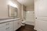 Elegant bathroom featuring a sleek granite countertop, modern fixtures, and a pristine tiled bathtub with shower.