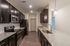 Modern kitchen with sleek dark cabinetry, stainless steel appliances, and elegant granite countertops.