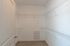 Spacious walk-in closet with ample shelving, perfect for organizing and maximizing storage in a modern apartment.