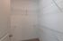 Spacious walk-in closet with ample shelving, perfect for organized storage in a modern apartment.