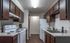Charming kitchen with modern appliances, sleek countertops, and ample cabinetry, perfect for culinary enthusiasts.
