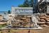 Inviting entrance to Rock Island Ridges at Riverchase featuring a charming waterfall and rustic stonework.