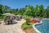 Luxurious outdoor pool area surrounded by lush greenery and elegant poolside cabanas, perfect for relaxation and entertainment.