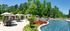 Luxurious outdoor pool area with elegant cabanas, sun loungers, and vibrant landscaping set amidst lush greenery.