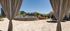 Luxurious apartment complex courtyard with elegant pool, palm trees, and inviting lounge chairs under a bright blue sky.