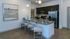 Chic modern kitchen with granite countertops, sleek appliances, and cozy bar seating, perfect for entertaining.