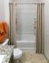 Elegant bathroom featuring a sleek bathtub, decorative shower curtains, and a granite countertop.
