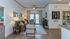 Charming modern living room with elegant decor, cozy seating, and abundant natural light through large windows.