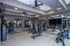 Modern apartment fitness center equipped with top-notch gym equipment, mirrored walls, and flat-screen TV for an enhanced workout experience.