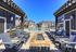 Inviting outdoor pool area with elegant lounge chairs and modern apartment buildings in the background, perfect for relaxation and leisure.