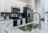 Modern kitchen with sleek stainless steel appliances, granite countertops, and elegant cabinetry.