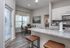 Modern apartment with open-plan kitchen and dining area, featuring sleek countertops, stylish cabinetry, and abundant natural light.