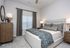 Inviting bedroom boasting a plush bed with chic patterned bedding, complemented by elegant wooden furniture and soft lighting for a cozy ambiance.