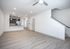 Spacious and modern open-concept living area with sleek hardwood floors, contemporary kitchen featuring stainless steel appliances, and stylish pendant lighting.