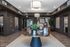 Elegant apartment lobby featuring sophisticated lighting, modern decor, and cozy seating areas, creating an inviting atmosphere.