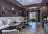 Sophisticated lounge area featuring elegant wooden tables, plush seating, and stylish animal wall decor, bathed in natural light for a cozy, upscale atmosphere.