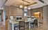 Contemporary communal workspace with sleek countertops, modern computers, and elegant lighting, perfect for productivity and comfort.