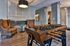 Chic apartment lounge featuring a modern foosball table, plush chairs, and elegant lighting, perfect for relaxation and entertainment.