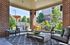 Charming outdoor patio with comfortable seating, elegant decor, and lush greenery, perfect for relaxing and entertaining.