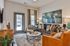 Chic living room with modern decor, comfortable seating, and abstract artwork, perfect for stylish relaxation.