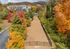 Charming apartment complex nestled amid vibrant autumn foliage, offering picturesque views and a serene environment.