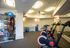 Modern fitness room with sleek exercise bikes and colorful medicine balls, offering a bright and inviting workout space.