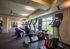 Bright, modern gym equipped with state-of-the-art exercise machines and floor-to-ceiling windows with scenic views.