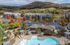 Charming apartment complex surrounded by stunning autumn foliage, featuring a luxurious swimming pool and cozy cabanas with a picturesque mountain backdrop.