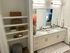 Modern bathroom with granite double vanity, stylish shelving, and elegant decor creating a serene ambiance.