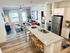 Modern apartment interior featuring a chic open-concept layout with a stylish kitchen island, cozy living room with natural light, and elegant wood flooring.
