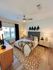 Cozy bedroom featuring elegant decor, a plush bed, and warm lighting in contemporary apartment.