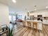 Modern open-concept apartment with elegant kitchen and cozy living area, highlighted by stylish decor and natural light.