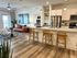 Contemporary open-concept apartment featuring a cozy living area with stylish decor, modern kitchen with granite countertops, and elegant hardwood flooring.
