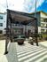 Chic outdoor seating area with modern pergola, comfortable sofa, and stylish decor, perfect for relaxation.