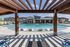Luxurious apartment complex with a sparkling swimming pool, modern cabana, and comfortable loungers under a stylish pergola.