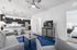 Modern living space with open-concept kitchen, sleek pendant lighting, and cozy seating; adjacent to a serene bedroom retreat.