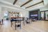 Chic communal space featuring modern dining area, stylish open kitchen, and elegant aquarium display.