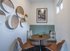Cozy dining nook with rustic wall baskets, stylish seating, and modern decor, perfect for intimate gatherings.