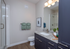 Modern bathroom with sleek granite countertop, elegant cabinetry, and a spacious glass-enclosed shower.