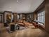 Sophisticated living area with modern furniture, cozy seating, stylish decor, and large windows providing ample natural light.