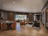 Elegant living area featuring modern decor, plush seating, and a stylish wooden dining table, illuminated by soft lighting.