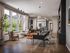Chic modern office space with abundant natural light, elegant furnishings, and a view of lush greenery.