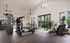 Modern fitness center featuring state-of-the-art cardio machines, sleek weight equipment, and bright natural lighting.