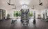 Spacious and modern gym featuring state-of-the-art fitness equipment, abundant natural light, and stylish plants for an invigorating workout experience.