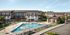 Modern apartment complex with inviting pool area, sun loungers, and stylish architecture, perfect for relaxed living.